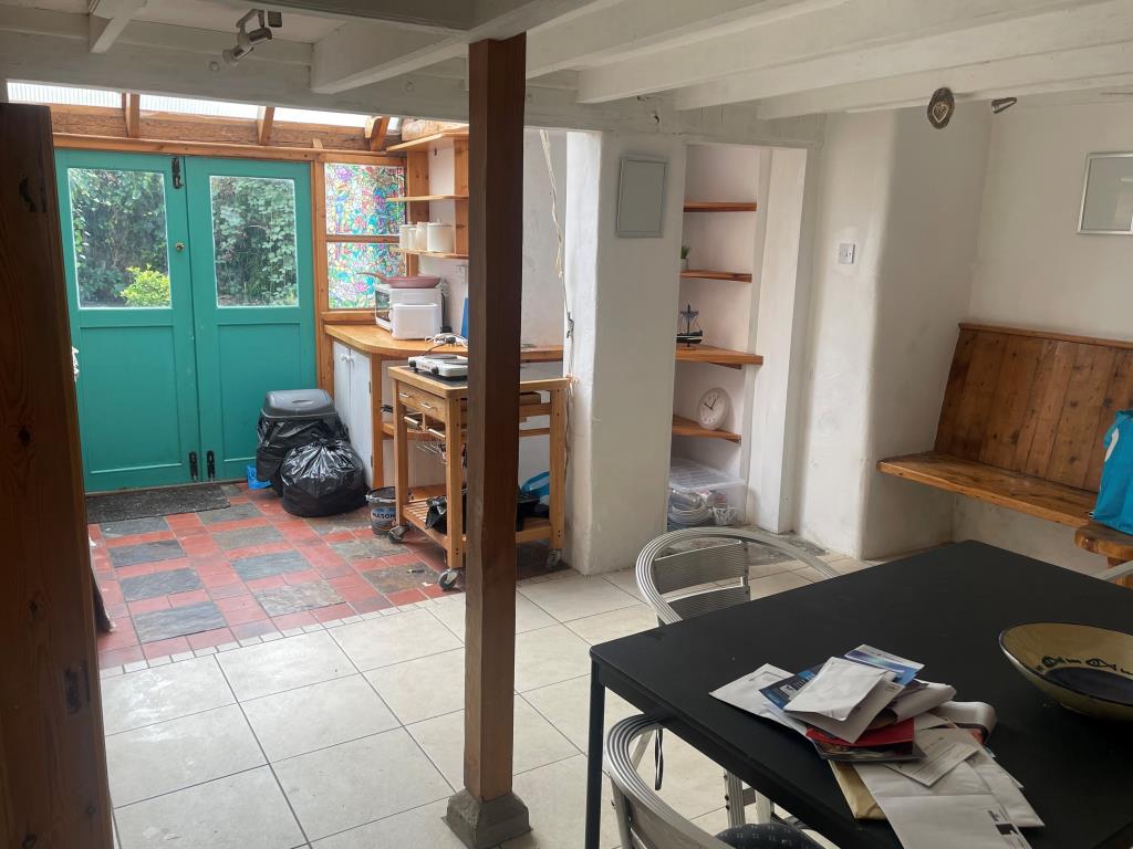 Lot: 27 - COTTAGE FOR IMPROVEMENT - Kitchen with double doors leading to rear courtyard